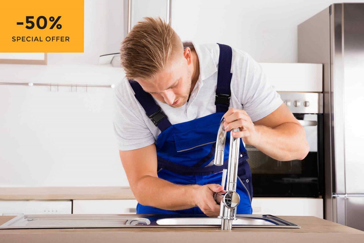 protect your plumbing in cold weather as plumber works on kitchen tap