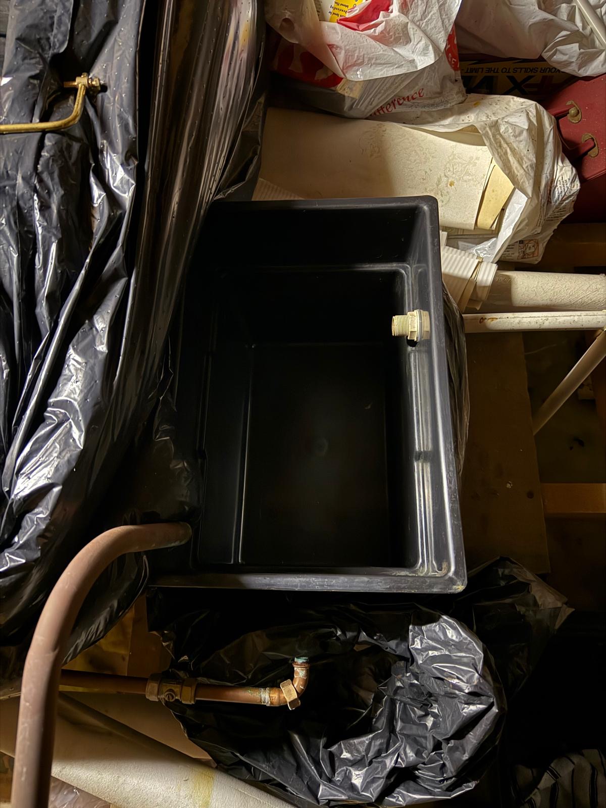 Old heating tank removed before replacement by Teddy Tails Plumbing in Worle